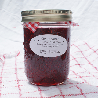 Jar of wild Maine raspberry jam.